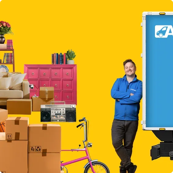 Image of furniture and moving boxes with a moving expert and van